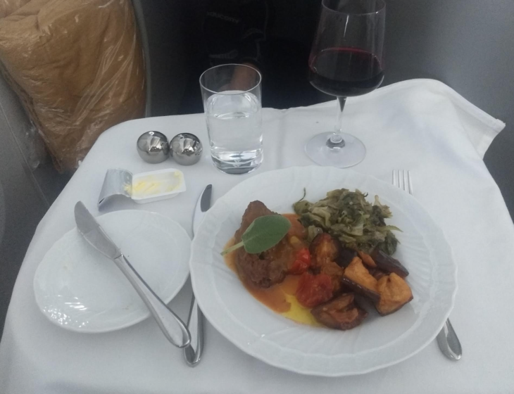 a plate of food and wine glasses on a table