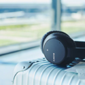 a black headphones on a silver suitcase