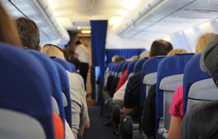 a group of people sitting in an airplane