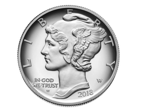 a silver coin with a face on it