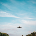 an airplane flying over a runway