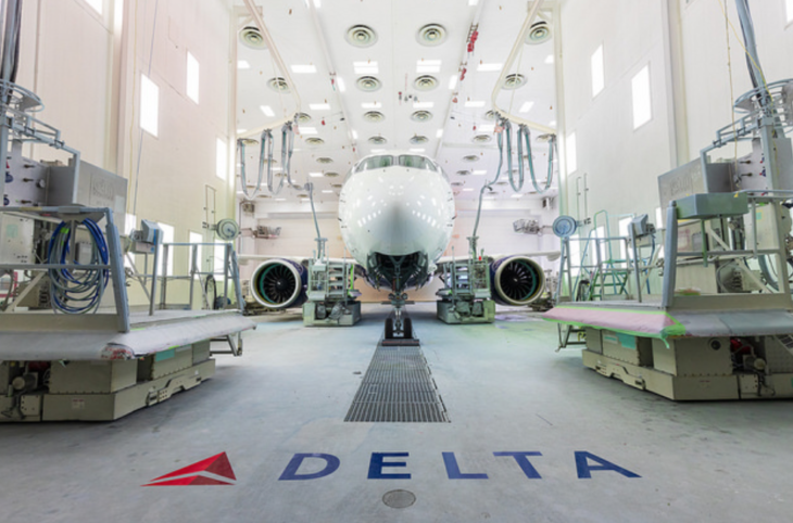 a white airplane in a hangar