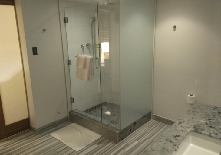 a glass shower with a stand up shower