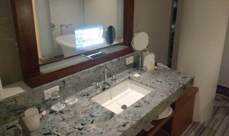a bathroom sink with a mirror and a mirror above it