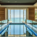 a pool inside a room with a large window