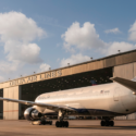 a large airplane parked in front of a building