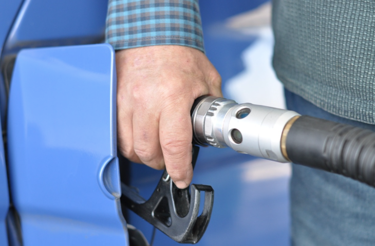 a hand holding a gas pump