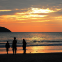 a group of people walking on a beach