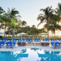 a pool with lounge chairs and umbrellas