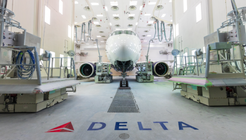 a white airplane in a hangar