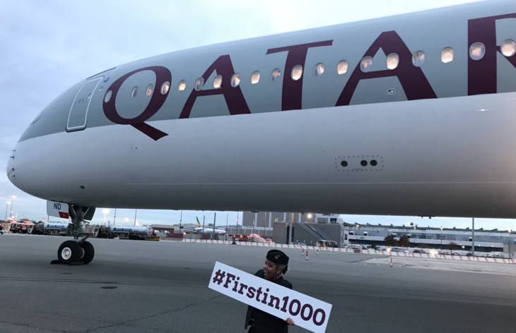 a person holding a sign next to a plane