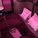 a bed with pillows and slippers on it
