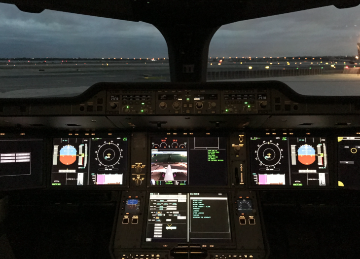 a cockpit of an airplane with a view of the runway