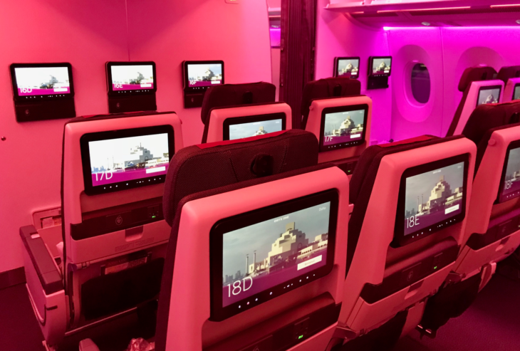 a row of seats with monitors on them