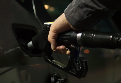 a hand holding a gas pump