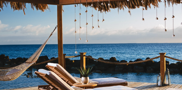 chairs on a deck by the water