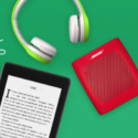 a tablet and headphones on a green surface