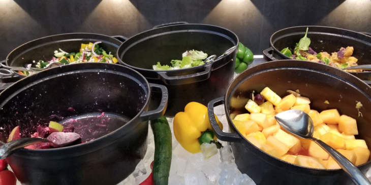 a group of black pots with food on a table