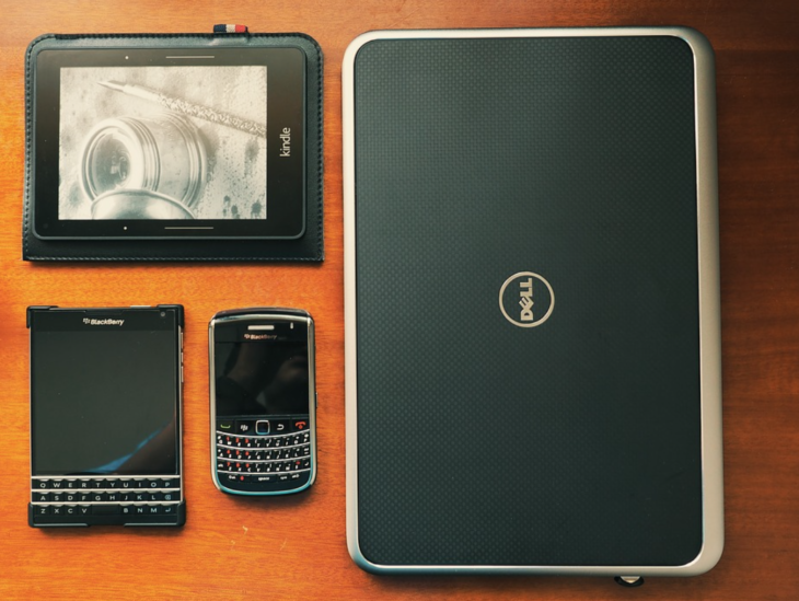 a tablet and cell phone next to a laptop