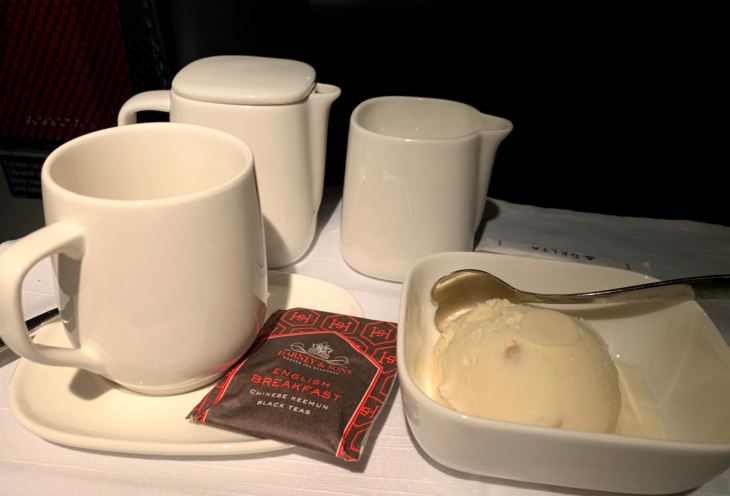 a white cups and saucers with a scoop of ice cream in it
