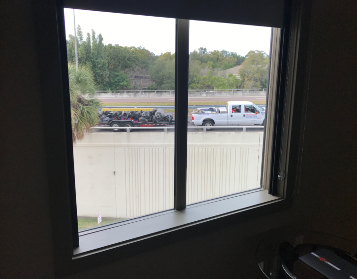 a window with a truck on the road