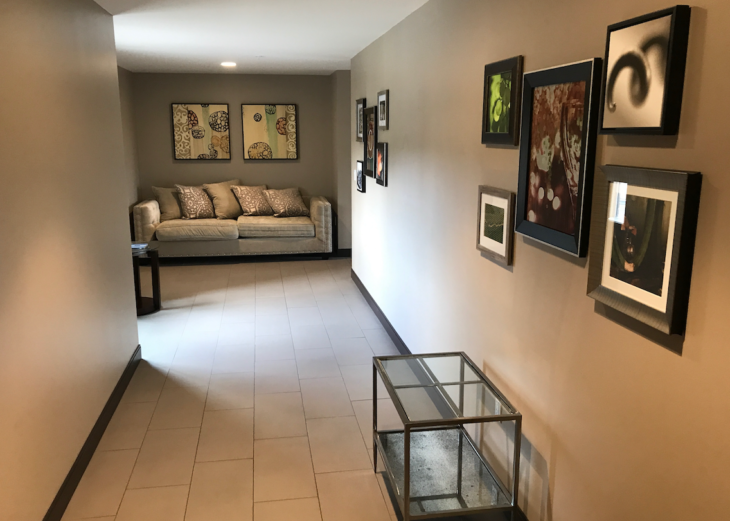 a hallway with a couch and pictures on the wall