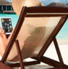 a person sitting in a chair on a beach