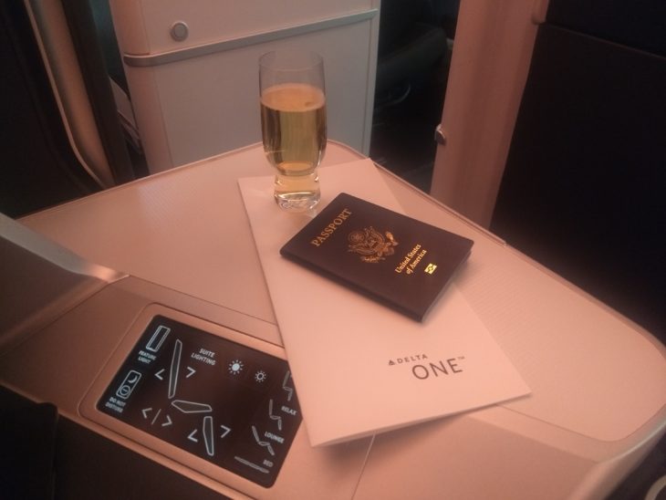 a glass of wine and a passport on a table