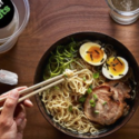 a bowl of ramen with chopsticks