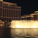 a water fountain with lights in front of Bellagio