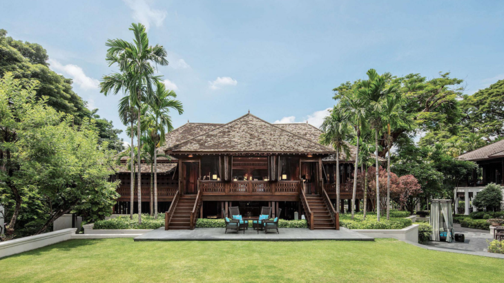 a building with a deck and chairs in front of it