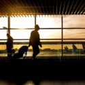 people silhouettes of people walking in an airport