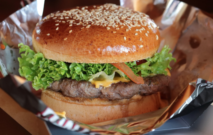a hamburger with lettuce and cheese