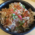 a bowl of food with meat and vegetables