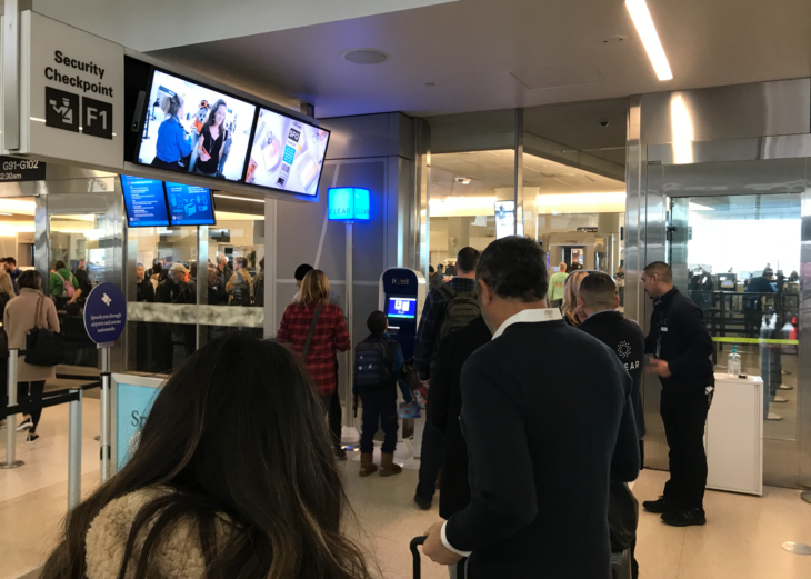 people standing in a line at an airport