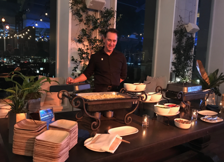 a man standing in front of a buffet