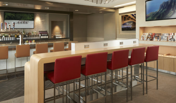 a bar with red chairs