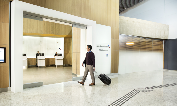 a man walking with luggage in an airport