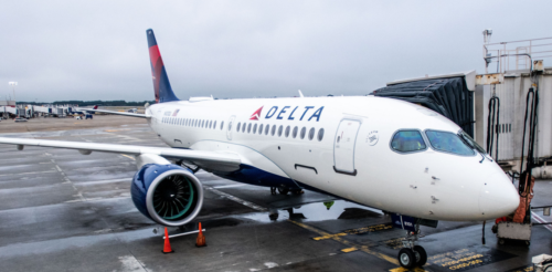 a white airplane with blue and red tail
