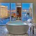 a large white bathtub with a view of the city