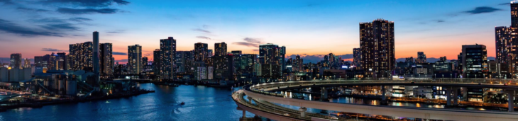 a city skyline with a bridge over water