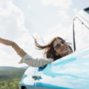 a woman in sunglasses leaning out of a car window