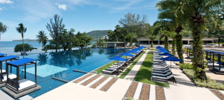 a pool with lounge chairs and umbrellas