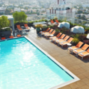 a pool with lounge chairs and umbrellas