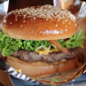 a cheeseburger in a paper basket