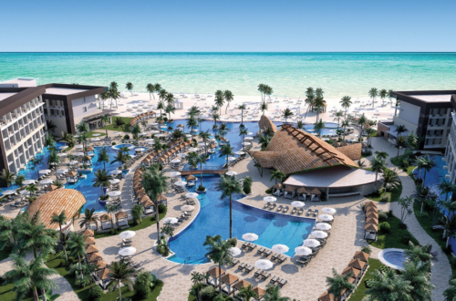 a resort with a pool and palm trees
