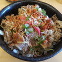 a bowl of food with meat and vegetables