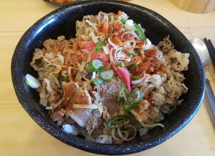 a bowl of food with meat and vegetables