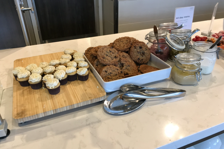 a tray of cookies and cupcakes on a counter