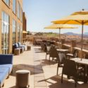 a patio with chairs and umbrellas